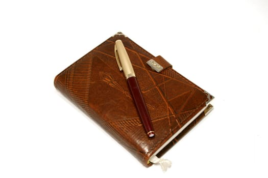 Brown leather pocket boor and red ink-pen