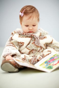 Small baby reading a picture book