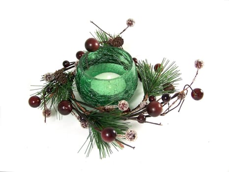 Green glass candlestick inside the garland as Christmas decoration