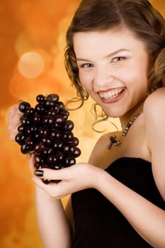 glamorous girl holding some grapes in her hand