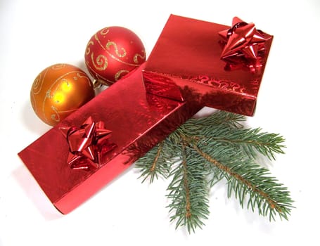 Two red gift boxes with fir-tree branch and two decorative balls