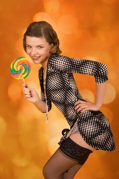 fashion girl with a rainbow lollipop
