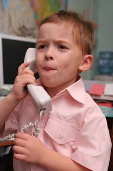 The boy speaks by phone in working hours