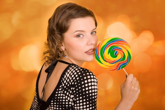 fashion girl with a rainbow lollipop