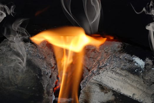 Flames licking over the fireplace log.