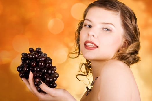 glamorous girl holding some grapes in her hand