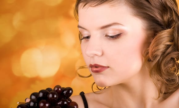 glamorous girl holding some grapes in her hand