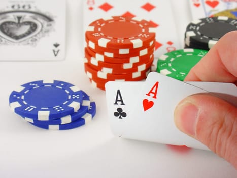 A pair of aces, chips and playing cards