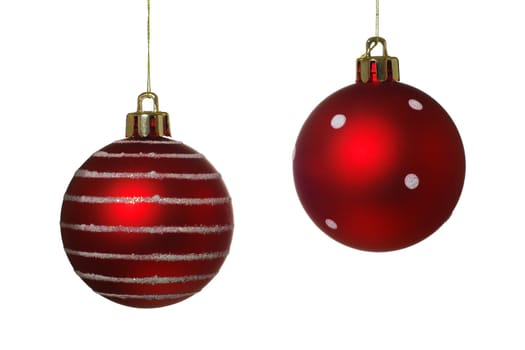 Two hanging Christmas baubles isolated on a white background