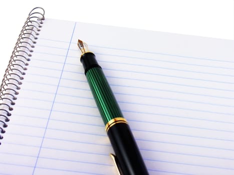 Spiral notebook with a fountain pen