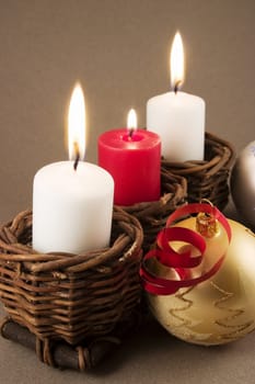 Christmas decoration with baubles, candle, stars