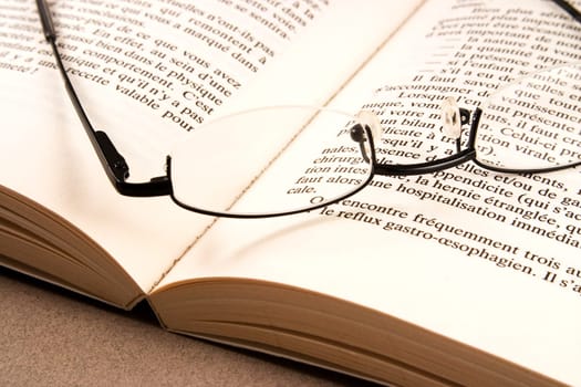 glasses on an open book