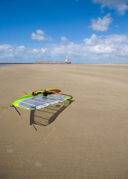 Cargo ship passing a beach with a surfboard on her way to the sea