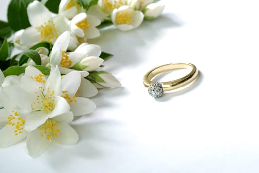 gold ring and jasmin flowers