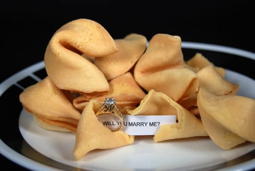 Marraige proposal and diamond ring found inside a fortune cookie.
