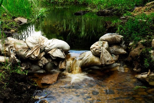 Sandbags create small waterfall in Destruction Brook in Dartmouth, MA