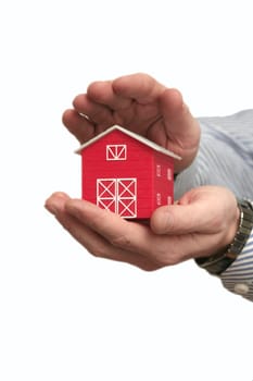 The man holds the red house in a hand