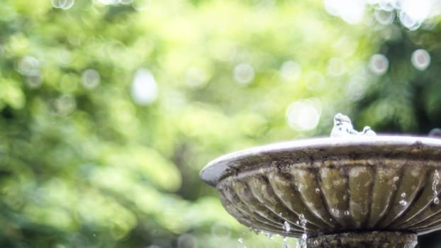 Antique fountain at garden. Water flowing from stone fountain. Design of antique fountain .calm and peacefulness concept idea