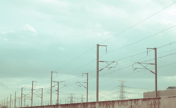 Street electricity poles  aligned  on the road with beautiful blue sky in background