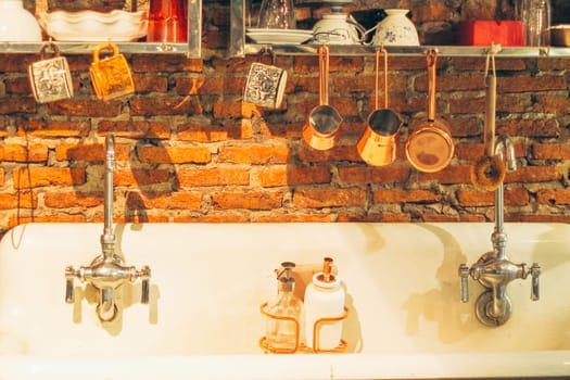 Vintage kitchen utensils on the wall above the sink. retro kitchenware retro kitchen