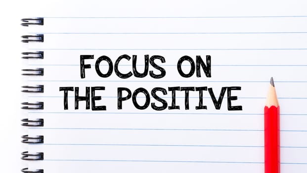 Focus On the Positive Text written on notebook page, red pencil on the right. Motivational Concept image