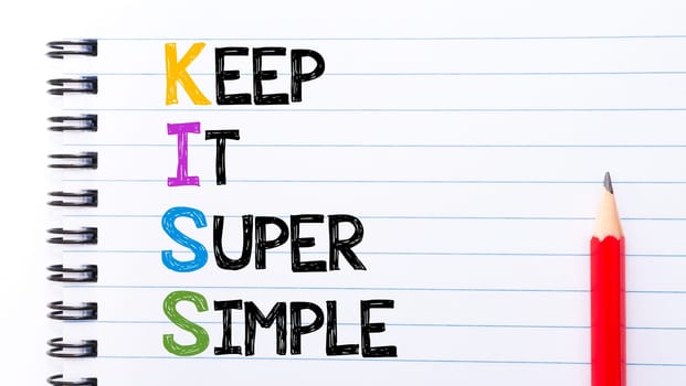 KISS as Keep It Super Simple Text written on notebook page, red pencil on the right. Motivational Concept image