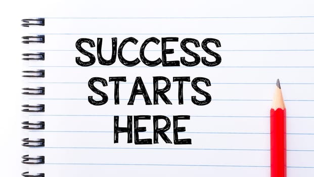 Succes Starts Here Text written on notebook page, red pencil on the right. Motivational Concept image