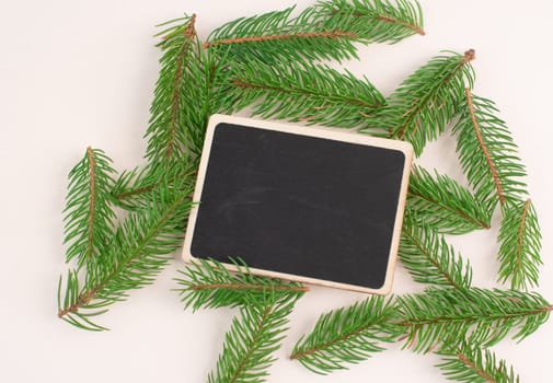 Christmas holiday background, chalkboard with fir branches, winter season greeting card with copy space