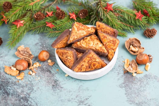 Nut corner triangles, traditional german sweets called Nussecke, covered with chocolate, christmas cake