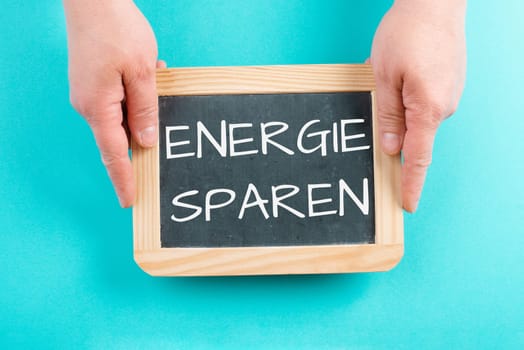 Save energy is standing in german language on the chalkboard, increase of electricity and gas costs, regulations for the winter, sanctions against russia