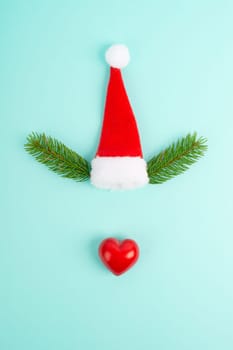 Face of a reindeer with a red heart nose, fir antlers and a santa claus hat, merry christmas greeting card