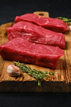 Closeup view of raw beef steak with spice on cutting board