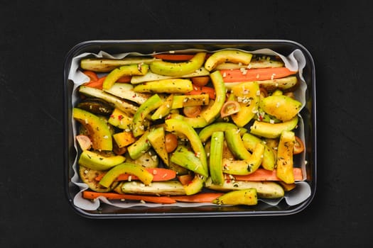 Spicy pumpkin and carrot in baking tray, top view