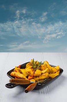 Spicy pumpkin and carrot baked in oven on ceramic plate