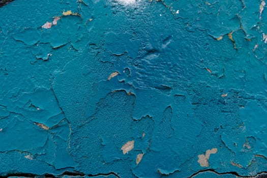 Colorful wall background with damaged paints of blue.