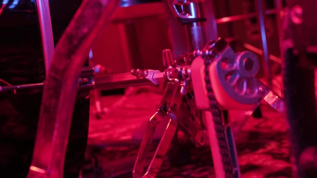 Drummer rehearsing on drum barrel before rock concert. Man recording music on drum set in studio in red light.