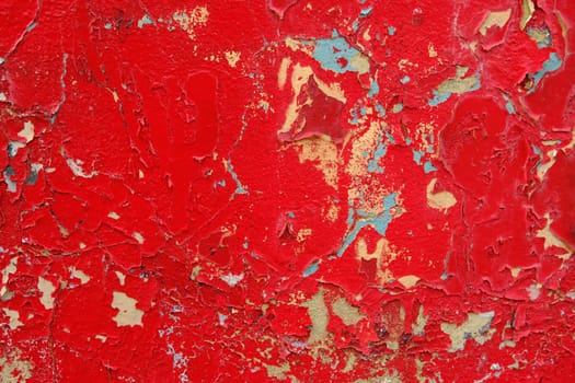 Colorful wall background with damaged paints of red.