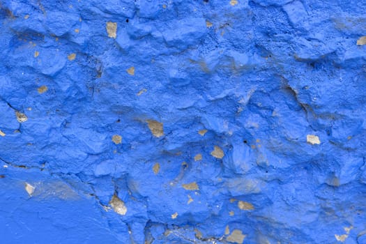Colorful wall background with damaged paints of blue.
