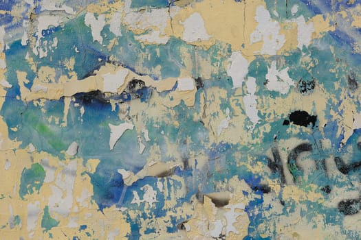 Colorful wall background with damaged paints of blue.