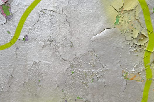 Colorful wall background with damaged paints of gray silver and yellow.