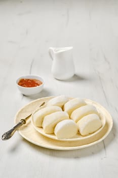 Closeup view of semifinished frozen lazy dumplings made of curd on a plate