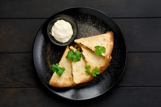 Top view of quesadilla with chicken meat, cheese and pickled cucumber with mayonnaise sauce