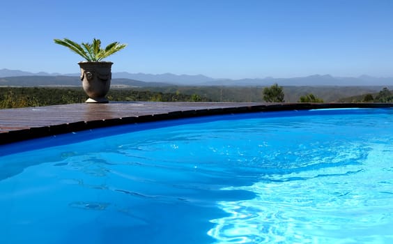 Sparkling blue outdoor pool with mountains in the background