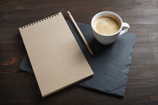 blank kraft sketchbook, pencil and coffee cup. Branding mock up.
