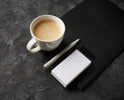 Blank business card, coffee cup, pen and usb flash drive.
