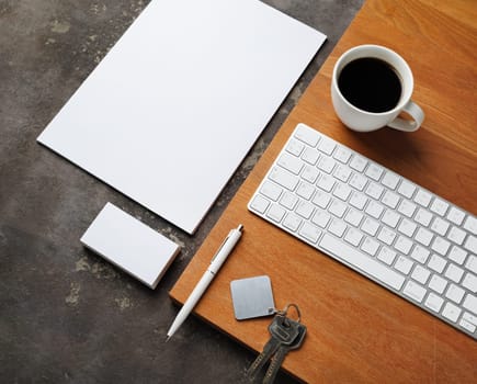 Blank stationery, keys, coffee cup and keyboard. Real estate agency concept.