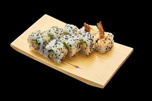 delicious Spice Ebi Maki roll on a wooden stand on a black insulated background. High quality photo