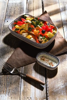 Salad with fresh tomato, bell pepper, cilantro, feta cheese and marinated black olives