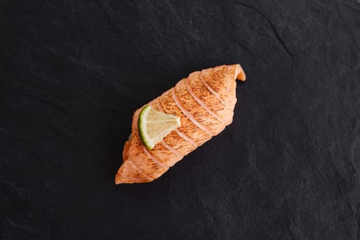 Sushi with seared salmon on slate plate