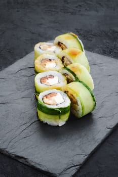 Rolls with eel, cucumber and tuna on slate plate